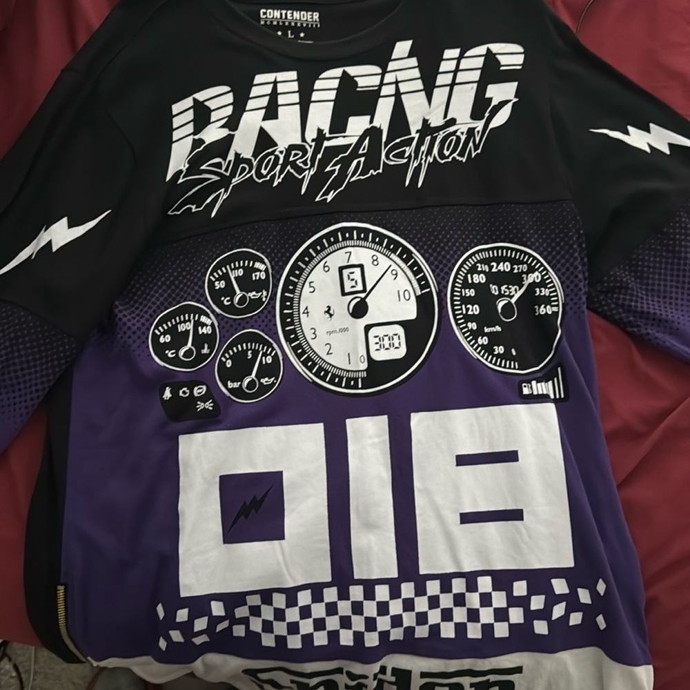 Lightly worn. Like new. Has zippers on both sides at the bottom of shirt